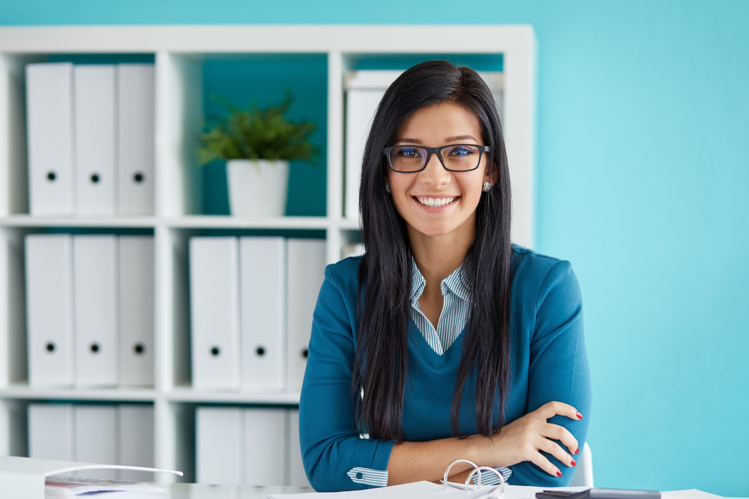 Young businesswoman with glasses working in modern office